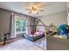 Bright bedroom with a house-frame bed near a window, complemented by a globe and dollhouse for a playful atmosphere at 4167 Alayna Lee Cir, Mcdonough, GA 30252