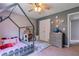 Charming bedroom featuring a unique house-frame bed, soft carpet, and a ceiling fan for comfortable living at 4167 Alayna Lee Cir, Mcdonough, GA 30252