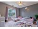 Shared ' bedroom with twin beds by the window, adorned with a princess-themed rug on the carpeted floor at 4167 Alayna Lee Cir, Mcdonough, GA 30252