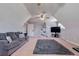 Bonus room with plush gray sofa and vaulted ceilings at 4167 Alayna Lee Cir, Mcdonough, GA 30252