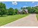 Beautiful home featuring a long driveway and lush green lawn at 4167 Alayna Lee Cir, Mcdonough, GA 30252
