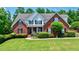 Charming brick home with well-manicured lawn and mature landscaping at 4167 Alayna Lee Cir, Mcdonough, GA 30252