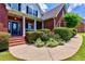 Inviting front porch with landscaped garden and covered entry at 4167 Alayna Lee Cir, Mcdonough, GA 30252