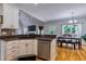Open kitchen with wooden floors and stainless steel appliances next to the dining area at 4167 Alayna Lee Cir, Mcdonough, GA 30252