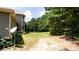 Expansive backyard with mature trees, a satellite dish, and lush greenery providing serene outdoor space at 240 Chandler Walk, Loganville, GA 30052