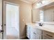 Bathroom featuring single vanity with large framed mirror at 240 Chandler Walk, Loganville, GA 30052