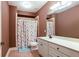 Bathroom featuring a shower-tub combo with a colorful shower curtain and a vanity with a white countertop at 240 Chandler Walk, Loganville, GA 30052