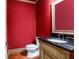 Powder room with a wood floor, granite countertops and red walls at 240 Chandler Walk, Loganville, GA 30052