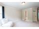 Bedroom with an attached bathroom and a seating area, featuring neutral decor at 240 Chandler Walk, Loganville, GA 30052