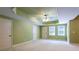 Spacious bedroom features tray ceilings, a ceiling fan, and ample natural light from three windows at 240 Chandler Walk, Loganville, GA 30052