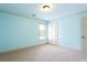 Bedroom featuring bright blue walls, carpet, and a window for plenty of natural light at 240 Chandler Walk, Loganville, GA 30052