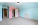 Bedroom with a walk-in closet, a blue painted wall, and neutral carpet at 240 Chandler Walk, Loganville, GA 30052