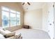 Bright bedroom with large windows, neutral carpet, a ceiling fan, and a cozy sitting area at 240 Chandler Walk, Loganville, GA 30052