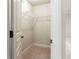 A walk-in closet featuring metal shelving and neutral carpet at 240 Chandler Walk, Loganville, GA 30052