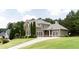 Well-maintained two-story home showcasing a lush lawn and spacious three-car garage at 240 Chandler Walk, Loganville, GA 30052
