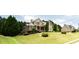 Suburban home with lush lawn, attractive landscaping, and neighboring house at 240 Chandler Walk, Loganville, GA 30052