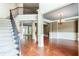 Grand foyer with hardwood floors, staircase, and elegant chandelier at 240 Chandler Walk, Loganville, GA 30052