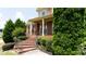 Inviting brick front porch with classic columns and wrought iron railings at 240 Chandler Walk, Loganville, GA 30052