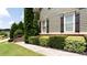 Beautifully landscaped front yard with manicured bushes and inviting sidewalk at 240 Chandler Walk, Loganville, GA 30052