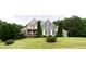 Attractive two-story home featuring lush landscaping and a well-manicured front yard at 240 Chandler Walk, Loganville, GA 30052