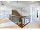 Hallway with wood railings, balusters and carpet flooring at 240 Chandler Walk, Loganville, GA 30052