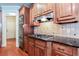 Gourmet kitchen boasts custom wood cabinetry, granite countertops, and stainless steel appliances at 240 Chandler Walk, Loganville, GA 30052