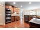 Well-equipped kitchen with stainless steel appliances, granite counters, and custom cabinets at 240 Chandler Walk, Loganville, GA 30052