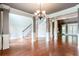 Open-concept living room featuring hardwood floors, columns, and a staircase at 240 Chandler Walk, Loganville, GA 30052