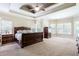 Large main bedroom boasts a tray ceiling, lots of windows, and room for a sitting area at 240 Chandler Walk, Loganville, GA 30052