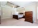 Bright main bedroom features a tray ceiling, lots of windows, and neutral carpeting at 240 Chandler Walk, Loganville, GA 30052