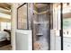 Tiled walk-in shower with decorative accent and glass door at 240 Chandler Walk, Loganville, GA 30052