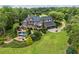 Aerial view of estate featuring pool, a three-car garage, and lush landscaping at 4239 Lower Jersey Rd, Covington, GA 30014