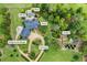 Aerial view of an estate featuring a helipad, koi pond, pool, fire pit, and gardens at 4239 Lower Jersey Rd, Covington, GA 30014