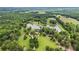 Expansive aerial view of a private estate featuring a large pond and manicured grounds at 4239 Lower Jersey Rd, Covington, GA 30014
