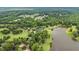 Breathtaking aerial view of a serene lakeside estate surrounded by lush trees and greenery at 4239 Lower Jersey Rd, Covington, GA 30014