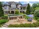 Gorgeous backyard with a luxurious pool, waterfall feature, fire pit, and patio area at 4239 Lower Jersey Rd, Covington, GA 30014