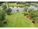 Aerial view of a well-manicured lawn that slopes down to a private lake at 4239 Lower Jersey Rd, Covington, GA 30014