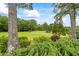 Green lawn in a secluded backyard is framed by mature trees and green shrubs at 4239 Lower Jersey Rd, Covington, GA 30014