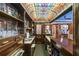 Features a full wet bar with intricate shelving and a colorful stained glass ceiling for an elegant look at 4239 Lower Jersey Rd, Covington, GA 30014