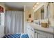 Bathroom features a tiled shower and a vanity with a white countertop and white cabinets at 4239 Lower Jersey Rd, Covington, GA 30014