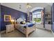 Bedroom with blue textured walls, carpet floors, a white bed frame, and a window seat at 4239 Lower Jersey Rd, Covington, GA 30014