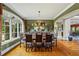 Formal dining room with hardwood floors, large windows, and decorative wood dining table at 4239 Lower Jersey Rd, Covington, GA 30014