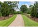 Picturesque driveway lined with wooden fences leading to a private estate at 4239 Lower Jersey Rd, Covington, GA 30014
