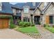 Stunning stone home featuring lush landscaping and charming front entrance at 4239 Lower Jersey Rd, Covington, GA 30014
