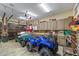 Well-lit garage with storage cabinets, golf cart, and four-wheeler at 4239 Lower Jersey Rd, Covington, GA 30014