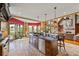 Open kitchen featuring a large island with seating, stainless steel appliances, and an adjacent living area at 4239 Lower Jersey Rd, Covington, GA 30014