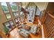 Open-concept living room with stone fireplace, large windows, and hardwood floors at 4239 Lower Jersey Rd, Covington, GA 30014