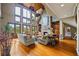 Inviting living room with stone fireplace, hardwood floors, and large windows offering scenic views at 4239 Lower Jersey Rd, Covington, GA 30014