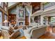 Bright living room featuring a stone fireplace, hardwood floors, and staircase to the second level at 4239 Lower Jersey Rd, Covington, GA 30014