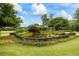 Beautifully landscaped pond in backyard with stone border, waterfall and colorful foliage at 4239 Lower Jersey Rd, Covington, GA 30014